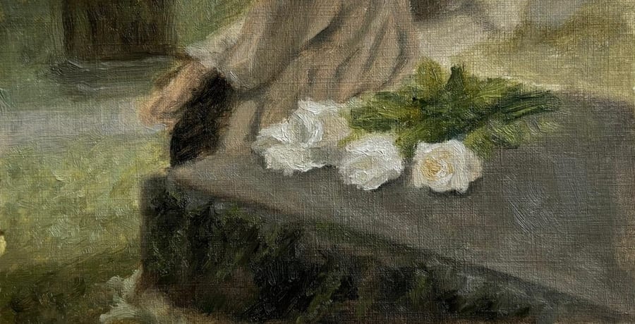 White roses with green stems lie across a grey stone ledge. Above them, the sleeve and hand of a figure in a pale coat move out of the frame, against soft green grass.